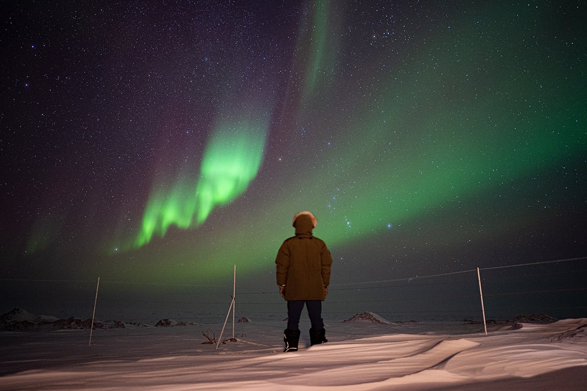 6-Private-Expedition-Home-Man-Observes-Aurora-Borealis-Northern-Lights-Private-Journey-Arctic-Polar-Adventure-Arctic-Kingdom